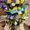 Yellow and white roses and lilies with seasonal flowers and lush greenery