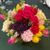 A joyful, colorful arrangement bursting with life &mdash; featuring hot pink roses