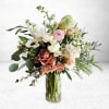 The Soft Echoes Arrangement is an ethereal gathering of creamy white ranunculus
