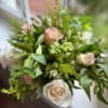 A soft and elegant arrangement of blush pink and ivory roses, creamy