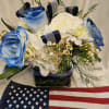 Classy, navy blue and white floral arrangement in a clear cube vase.