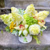 A Designer&#039;s Choice mixed floral arrangement that features summer flowers like dahlias