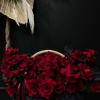 A huge brown basket with beautiful large, inverted roses with long ribbons