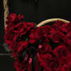 A huge brown basket with beautiful large, inverted roses with long ribbons