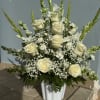 A serene arrangement of elegant white roses, snapdragons, gladiolus, and baby&#039;s breath