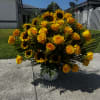 A radiant altar arrangement featuring 20 golden yellow roses, 6 bright sunflowers