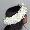 A white lei po&#039;o (Hawaiian flower crown) made with orchids and baby&#039;s