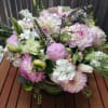 Featuring pink varigated dahlias, tulips, veronica, spray roses, stock and seasonal greens.