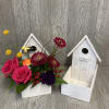 A cute wooden bird house with flowers, bird, and a mushroom! Flowers