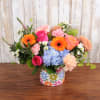 Bright and colorful summer blooms in a keepsake bright flower container!