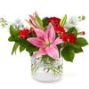 With an abundant blend of colorful blooms in a cinched glass vase
