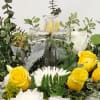A soft and gentle wreath spray in white and yellow with clear