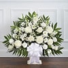 A beautiful sympathy floor basket hand arranged with stunning white flowers. Created