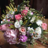 This cheerful and spunky arrangement features joyful spring blooms including spray rose
