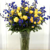 A radiant combination of sunshine-yellow spray roses and striking blue delphinium blooms