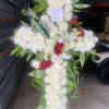 Standing cross crafted with white mini calla lillies, white spray roses, and