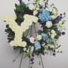 18 inch floral wreath lavishly filled with blue and white blooms and
