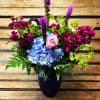 Blissful blue. A cobalt blue vase filled with brilliant blue, fuchsia and