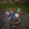 Seasonal blooms arranged in a vintage style embossed keepsake tin planter. Bright