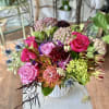 Vibrant, seasonal array of flowers arranged in a ceramic vase.