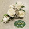 Wrist corsage containing 5 white spray roses with baby&#039;s breath, 2 iridescent