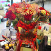We design a dozen mixed roses in a vase with gold butterflies