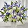 Designed with a fresh mix of blue and white flowers, this tribute