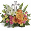 Nestled among bright orange gerberas, pink roses and white lilies, this precious