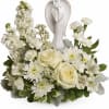 Peaceful and majestic, a graceful angel rests amongst fragrant, snow white roses