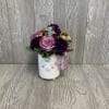 A sweet and sparkly fresh cut flower arrangement. In a keepsake ceramic