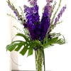 Oversized tall, dramatic bouquet of deep purple  flowers in Pilsner vase