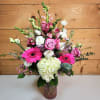 The Blushing Meadow arrangement is a vibrant, romantic bouquet that captures the