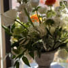 Flowers: coral garden roses, ivory spray roses, white freesia, anemones, white hypericum