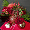 A blend of Protea, roses, Spruce, Yarrow, and Hypericum. This arrangement pulls