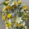 Standing easel open wreath with a plush bear, yellow and white florals