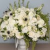 Elegant and ethereal, this lush floral arrangement features a serene palette of