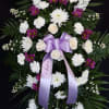 white roses, stocks, and mum featuring a splash of purple accent. ribbon
