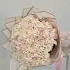 Featuring lush garden roses nestled among fluffy hydrangeas, this bouquet is a
