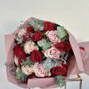 This bouquet intertwines the timeless passion of red roses with the delicate