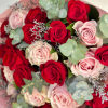 This bouquet intertwines the timeless passion of red roses with the delicate