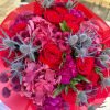 This bouquet is like a vibrant celebration of bold red roses mingling