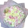 This delicate arrangement feels like a soft embrace captured in florals. Featuring
