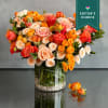 Upscale and uptown, this fantastic arrangement features Orange roses, peach spray rose