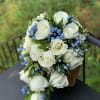 Natural bouquet light blue flowers and white roses.