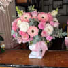 Coquette floral arrangement in pastel shades consisting of roses, gerberas, carnations, poms