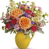 Pour on the sunshine! Filled with radiant roses, this cheerful yellow pitcher