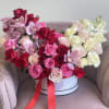 A breathtaking ombr&eacute; rose and orchid arrangement that seamlessly transitions from soft