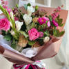 A front-facing bouquet with hot pink, white, and brown tones, wrapped in