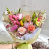 A front-facing bouquet with pink, lavender, peach, green, yellow, hot pink, and
