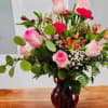 Beautiful Pink Roses, carnations, autumn alstroemeria and lush greenery in a beautiful